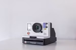 White instant camera on a table