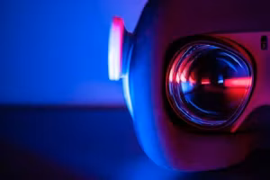 Close-up of a projector lens in blue light