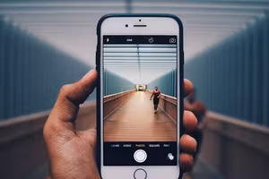 Hand holding a smartphone taking a photo
