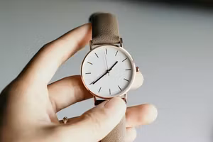 Hand holding a minimalist analogue watch